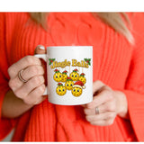 Person holding a white mug with 'Jingle Balls' design against a red background